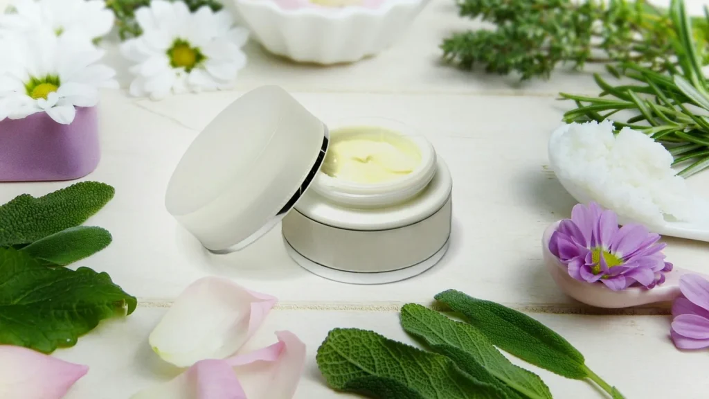 An opened beauty box filled with assorted skincare and makeup products and tissue paper.