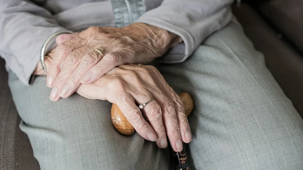 Close-up of a woman rubbing hand cream into her hands.