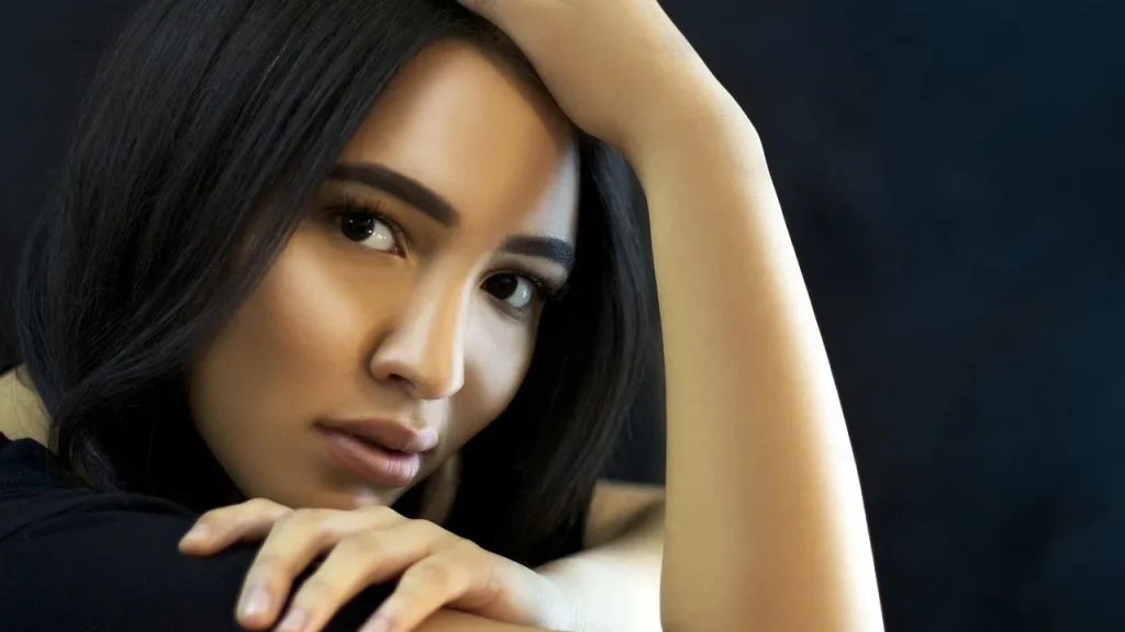 A close-up of a woman applying a smoothing cream for a flawless, blurred-pore look.