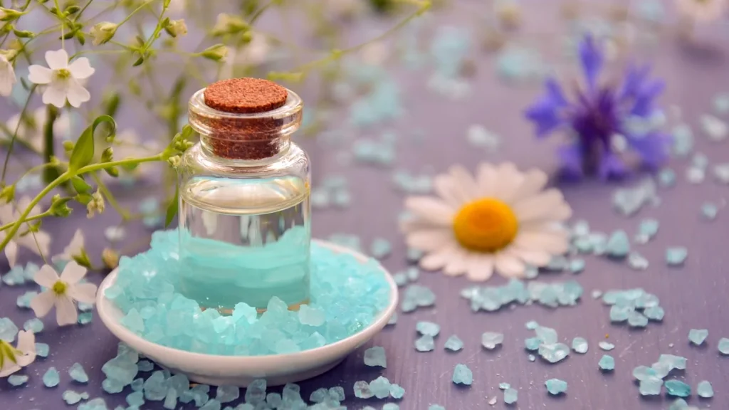 A bottle of bath and massage oil with an orchid flower, beside a woman receiving a relaxing massage.