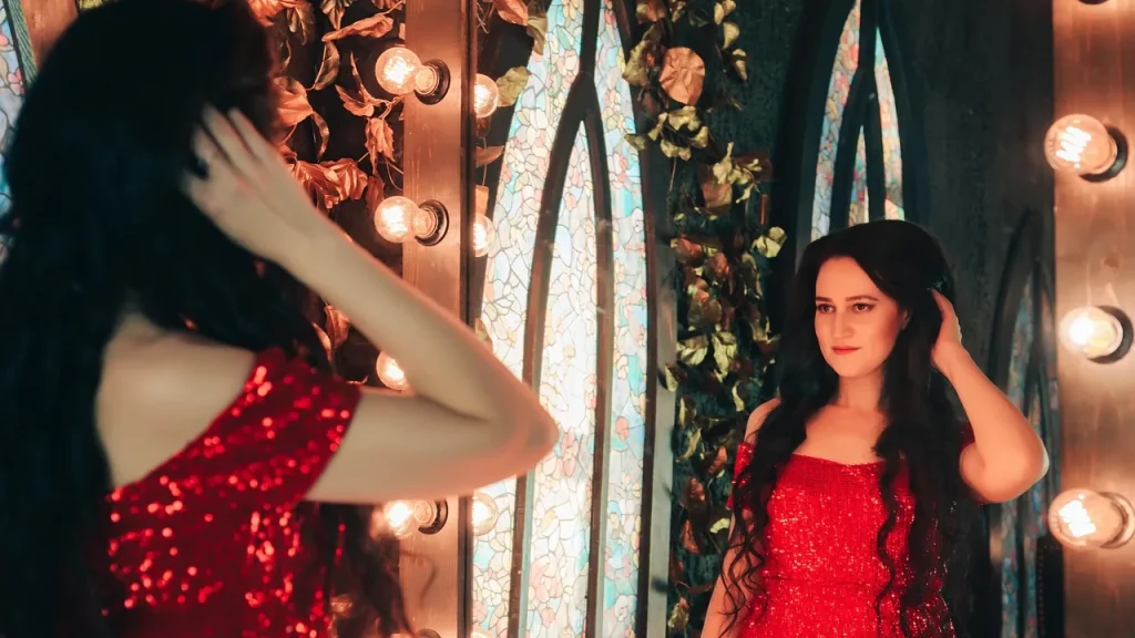 A woman with long, shiny, healthy hair brushing it gently.