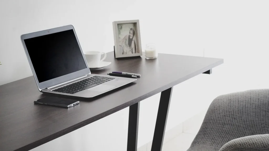 A bright, tidy hallway with framed posters and a small desk corner for remote work.